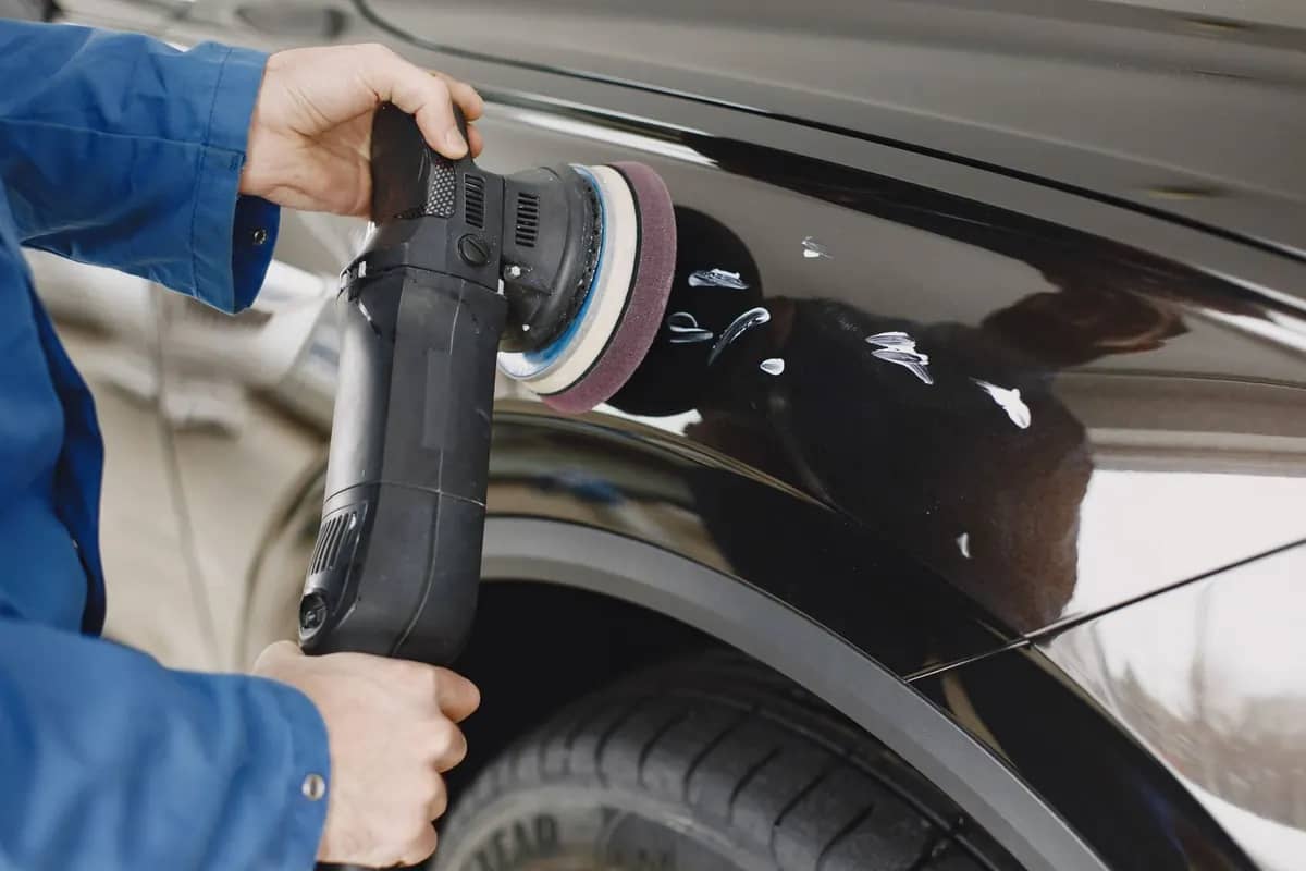 Otomobilin boyalı yüzeyinde makineyle polisaj uygulaması
